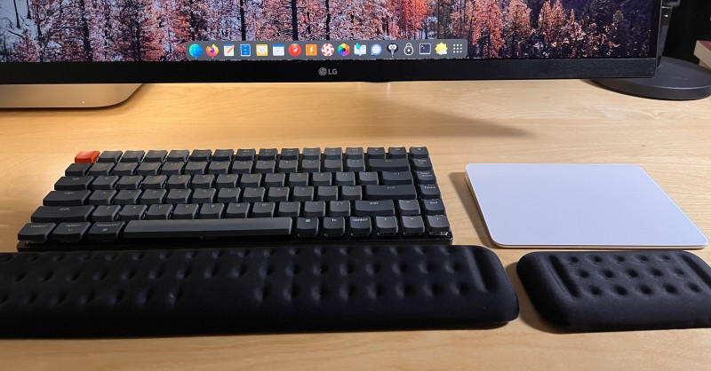 Bulky wrist rests in front of a keyboard and trackpad